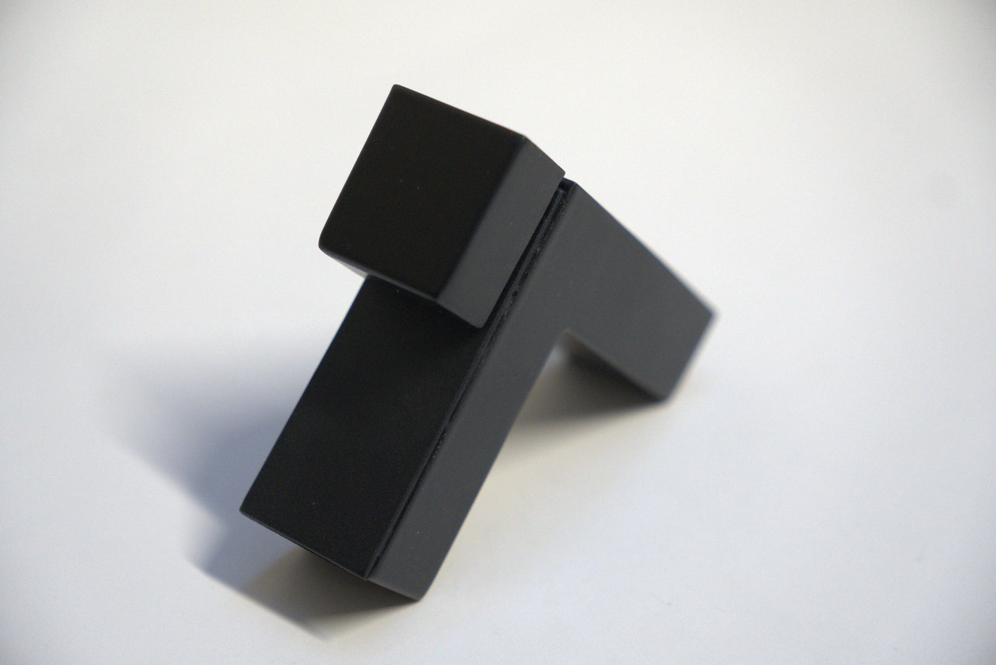 Square showcase shelf bracket from Best Glass Parts, with a tap design, mounted on a display shelf for supporting glass or display panels.