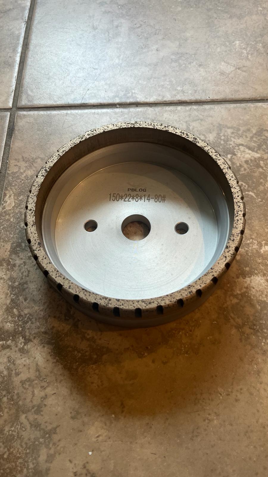 Close-up of a diamond wheel from Best Glass Parts, showing the textured abrasive surface used for precision glass cutting.