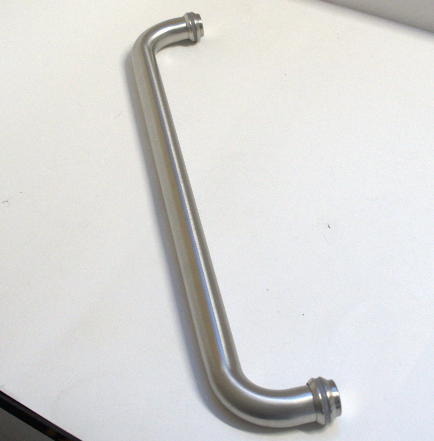 Round chrome towel bar by Best Glass Parts, mounted on wall with a sleek, modern design for bathroom organization.