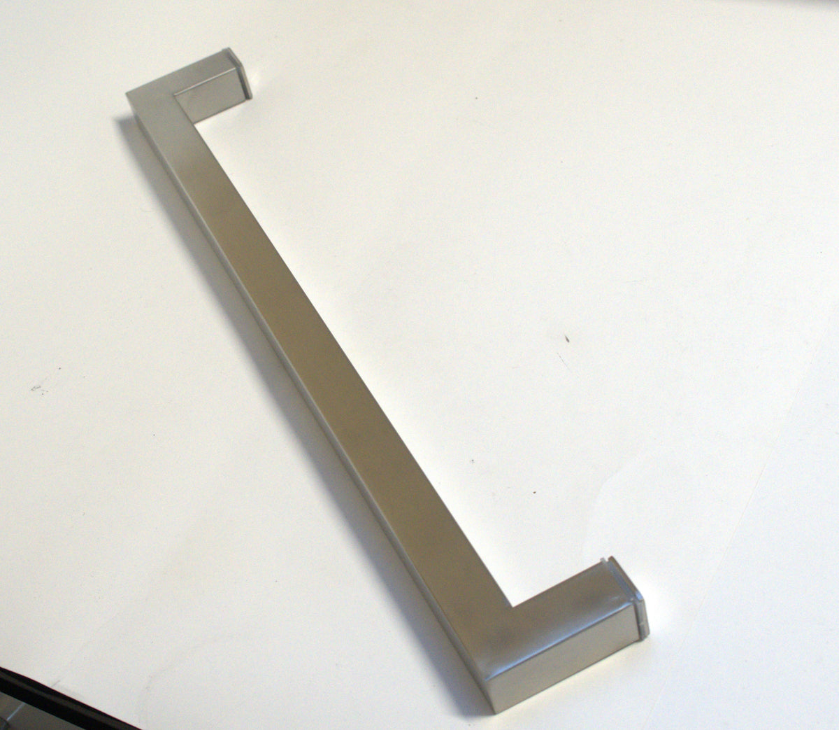 Chrome square towel bar from Best Glass Parts, mounted on a bathroom wall with a sleek, modern design.