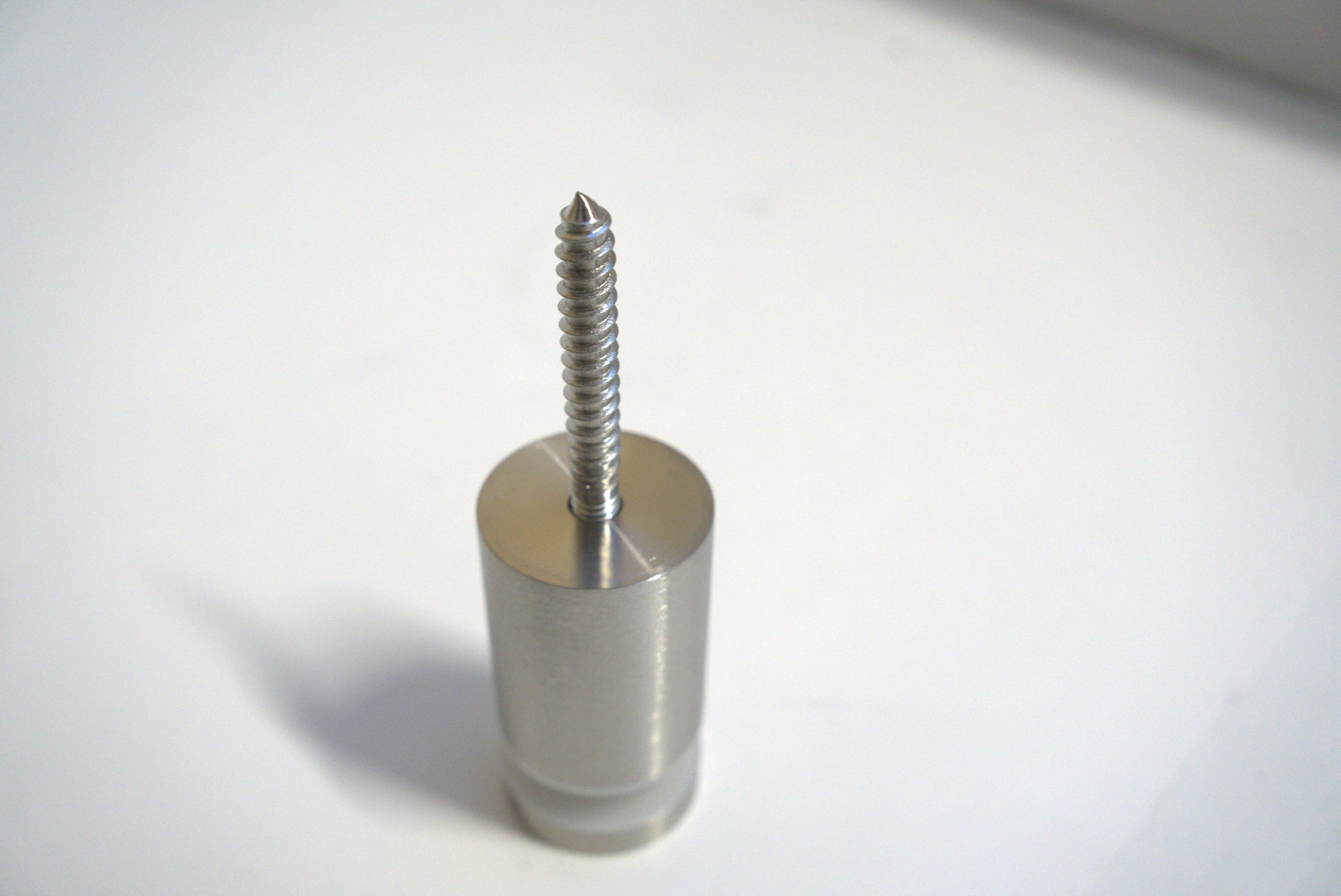 Best Glass Parts stand-off fix, clear mounting hardware with metal spacers for secure glass installation, shown in close-up detail.