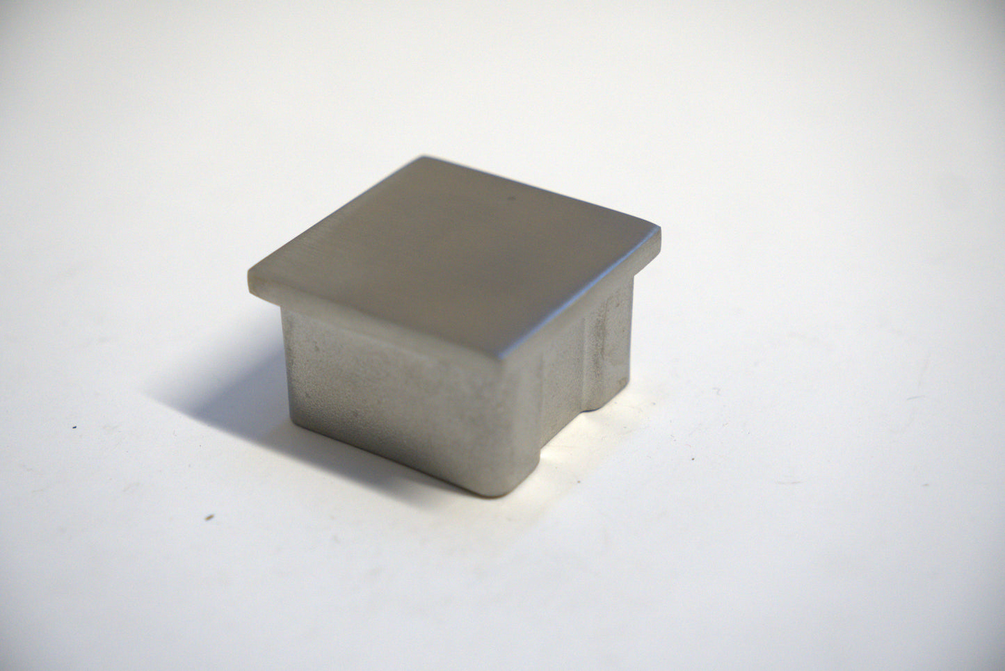 Square handrail end cap for railing top, designed by Best Glass Parts, shown in a sleek, silver finish.