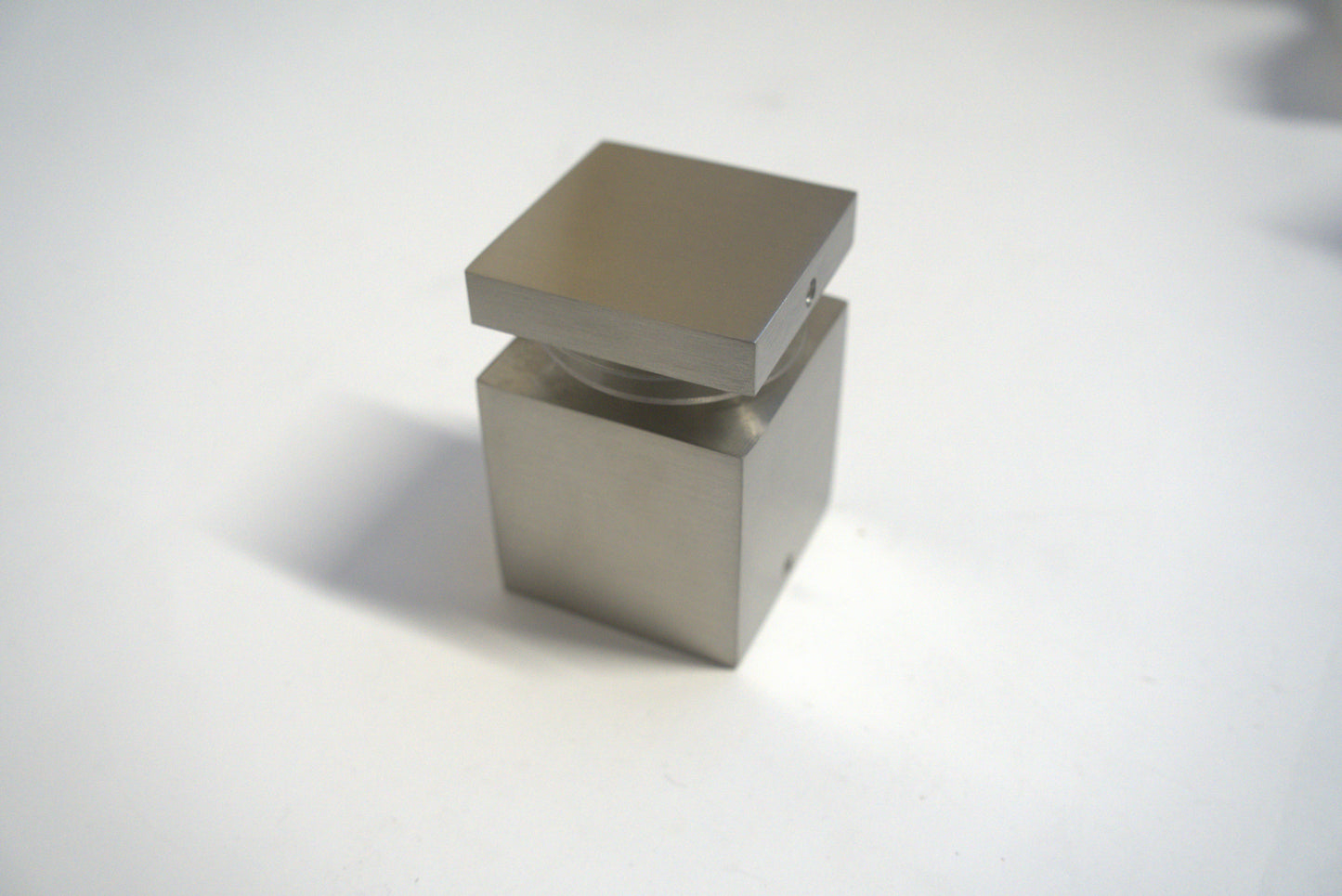 Square stand off 2x2 inches from Best Glass Parts, with a polished metal finish for glass mounting and support.