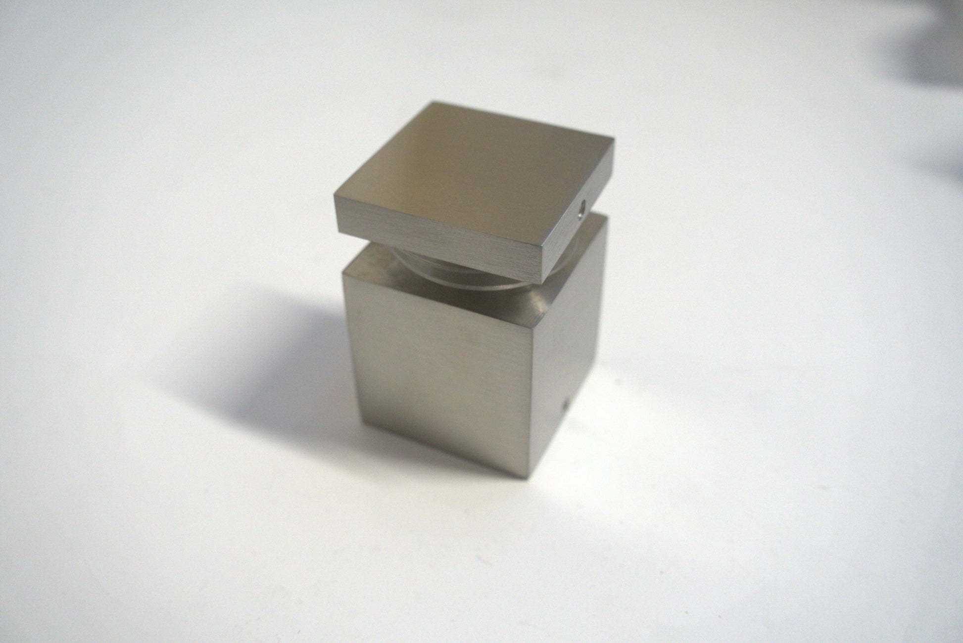 Square stand off 2x2 inches from Best Glass Parts, with a polished metal finish for glass mounting and support.
