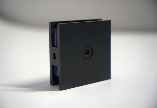 Black wall to glass clamp from Best Glass Parts, showing a sturdy metal fitting designed to secure glass panels to walls.