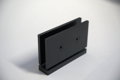 Geneva hinge pivot for glass doors, top and bottom, with curved design, by Best Glass Parts, mounted on clear glass.