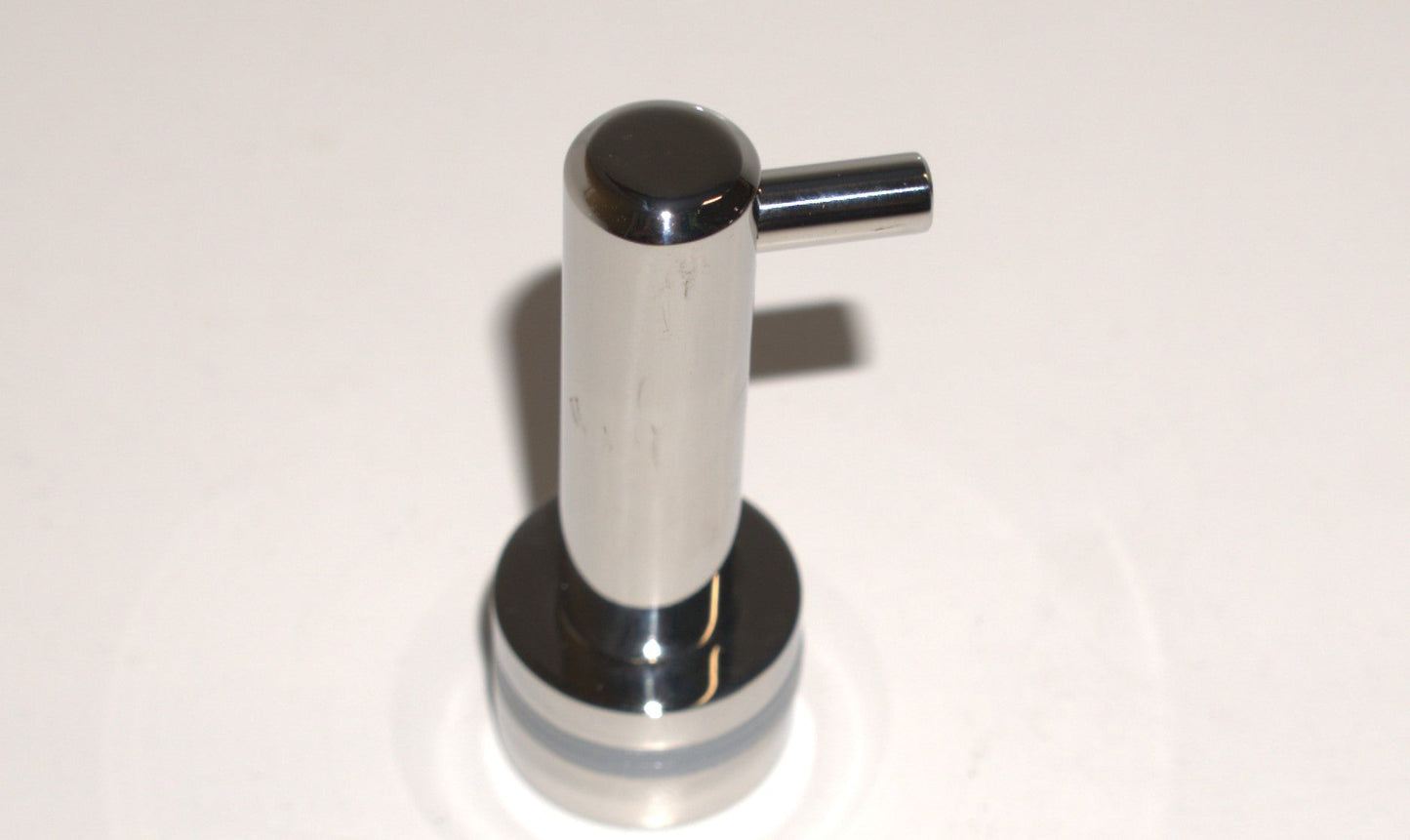 Best Glass Parts knob robe hook mounted on a wall, showing its sleek design and polished finish for hanging robes or towels.