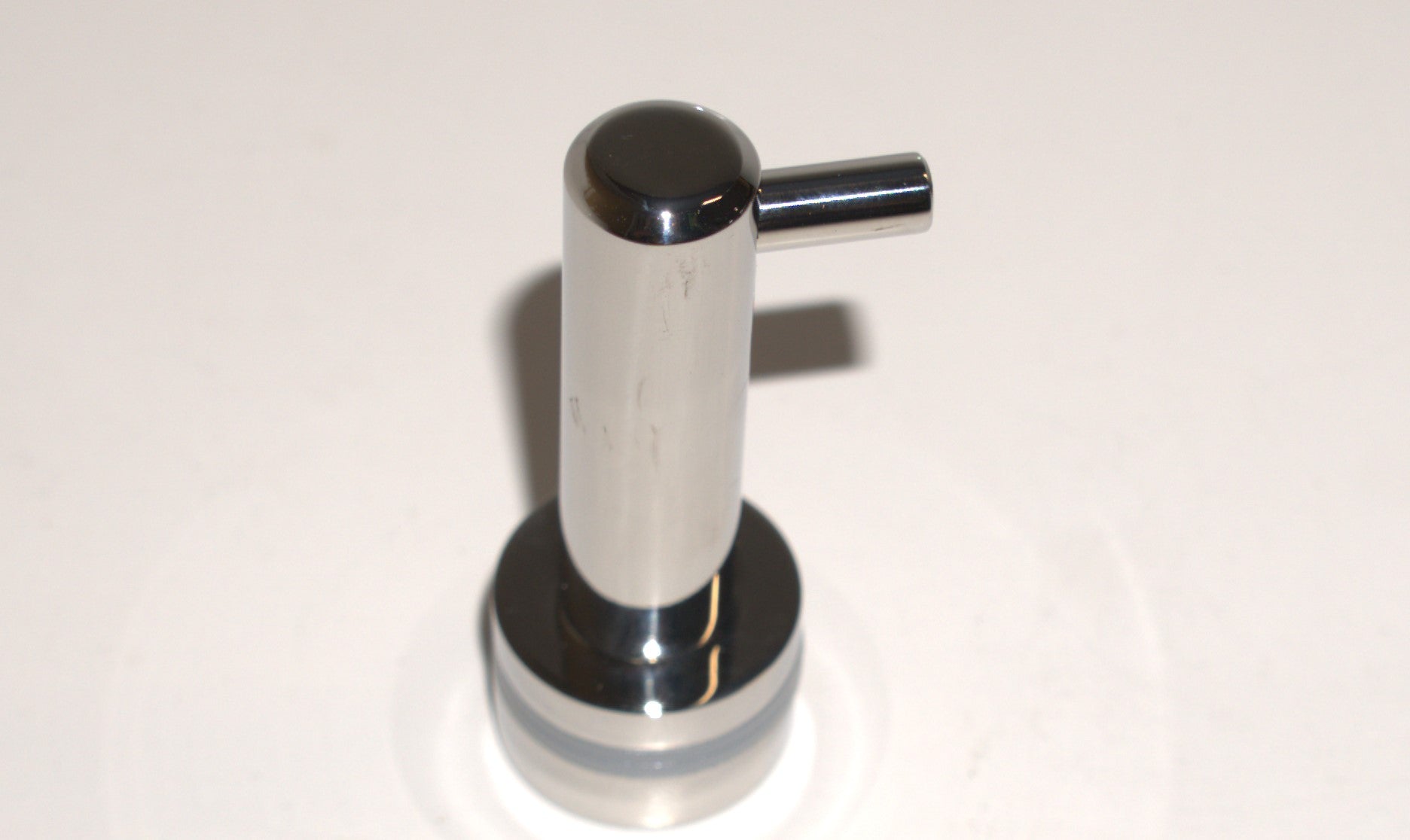 Best Glass Parts knob robe hook mounted on a wall, showing its sleek design and polished finish for hanging robes or towels.