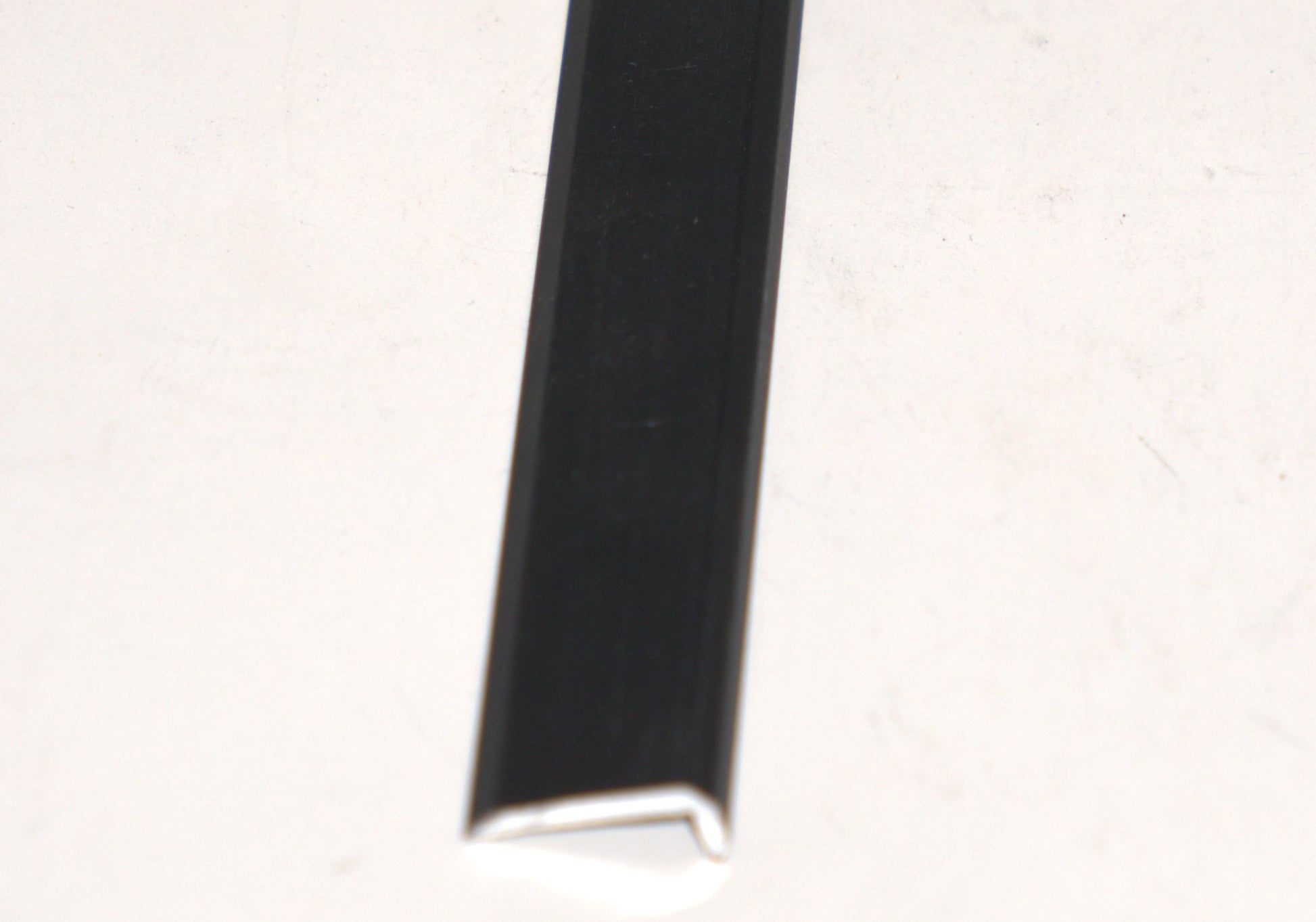 Black 1-inch mirror trim from Best Glass Parts, 144 inches long, showing a close-up of the sleek, flexible glass edging.