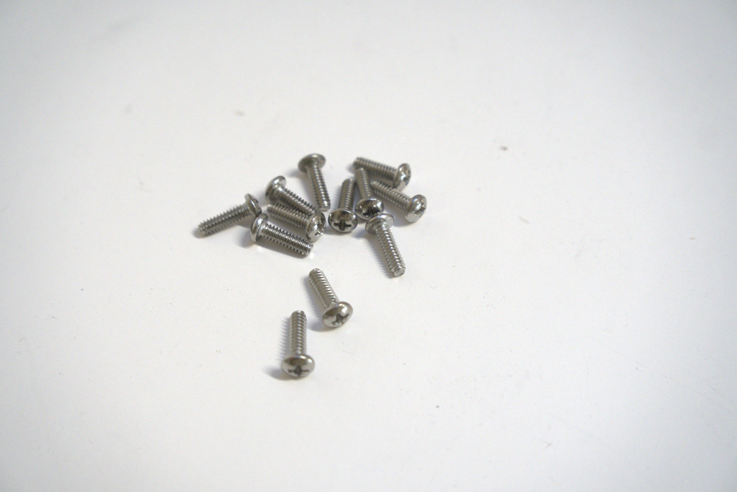 Metal machine screw from Best Glass Parts, close-up showing shiny steel threads and hex head for secure fastening.