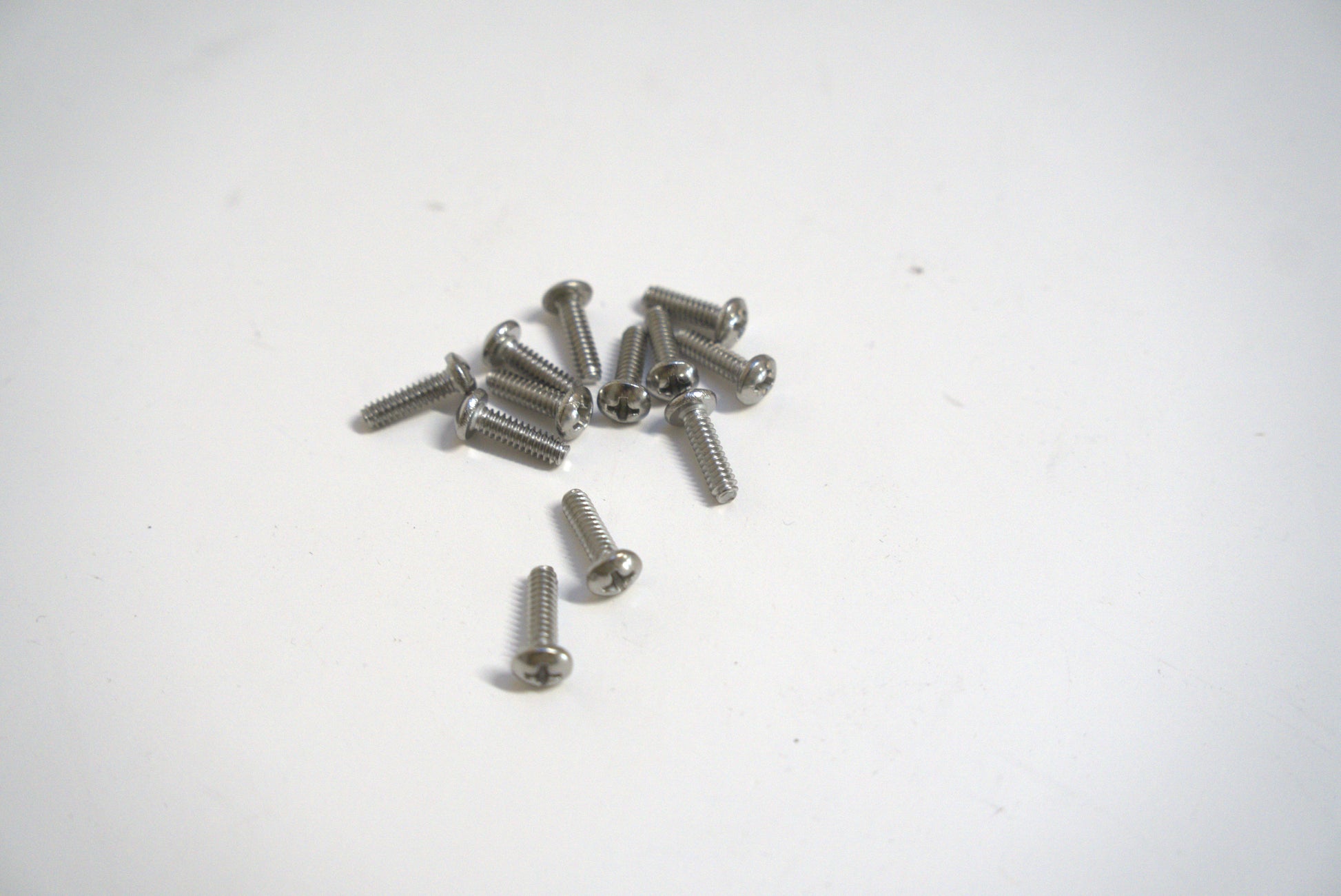 Metal machine screw from Best Glass Parts, close-up showing shiny steel threads and hex head for secure fastening.