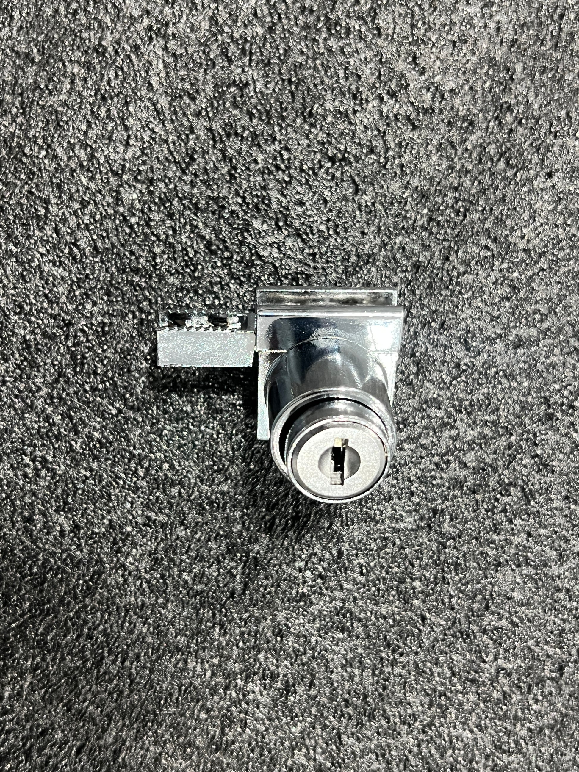 Clear glass showcase lock from Best Glass Parts, showing the locking mechanism and transparent glass enclosure.