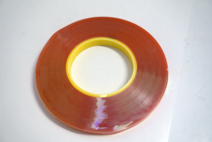 Double-sided clear tape from Trim Tessa by Best Glass Parts, showing the transparent adhesive strip on a plain background.